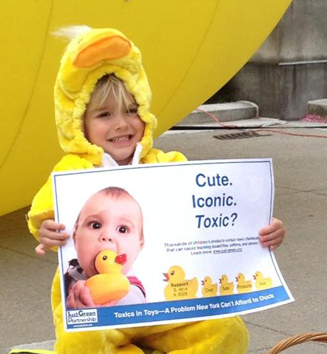 A child protests harmful chemicals in children’s toys.