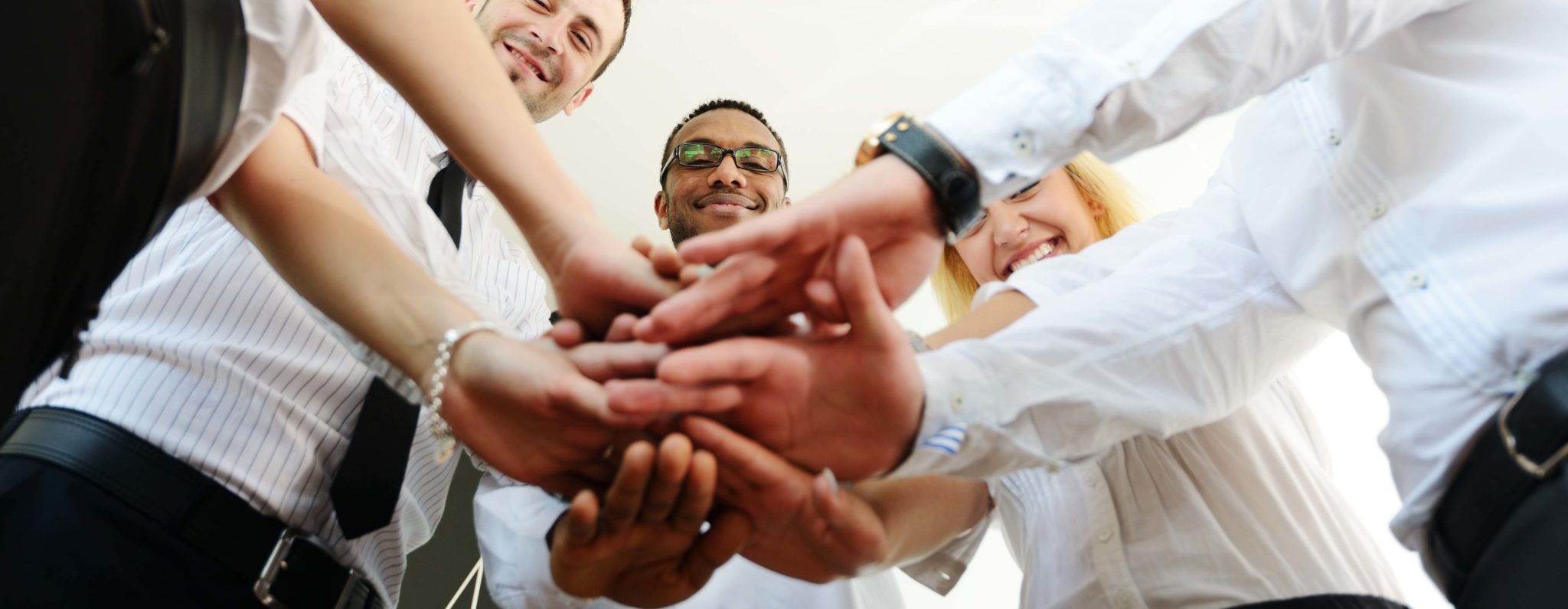 Business colleagues with their hands stacked together